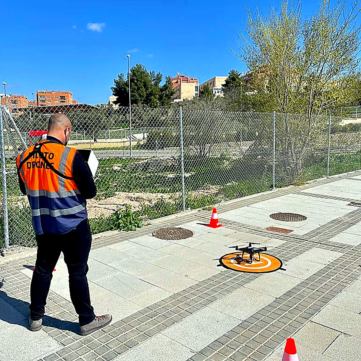 Piloto de drones realizando un levantamiento topográfico en una parcela urbana